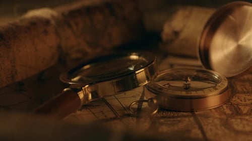 Vintage Compass and Magnifying Glass on Antique Map