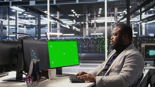 Data Center Programmer Coding on Green Screen PC Monitoring AI Systems