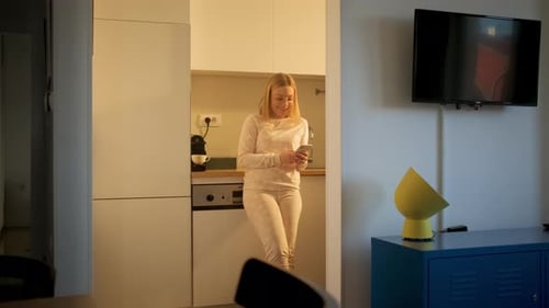 Smiling woman working remotely from home on her laptop.