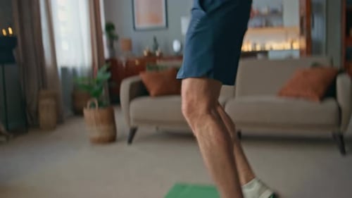 Man Doing Cardio Workout on Green Mat