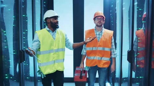 Two Construction Workers are Discussing the Important Safety Protocols on Their Job Site