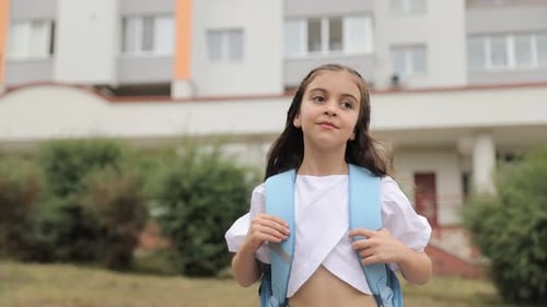 Little Pretty Girl with Turquoise Backpack Going to School Outdoors