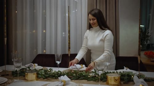 Woman Prepares Festive Holiday Table in Home