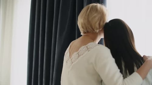 Loving Moment Between Two Women Embracing Indoors