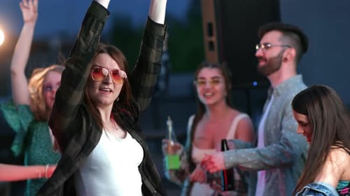 Happy Friends Dancing at an Outdoor Party