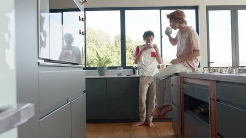 Young Adults Enjoying Coffee in a Modern Kitchen