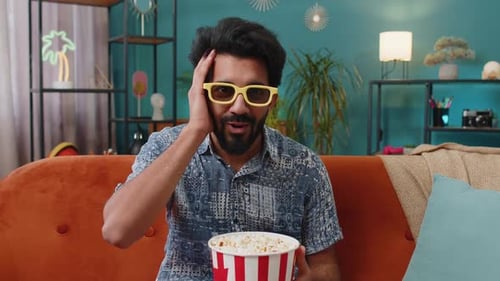 Surprised Man Watching 3D Movie at Home