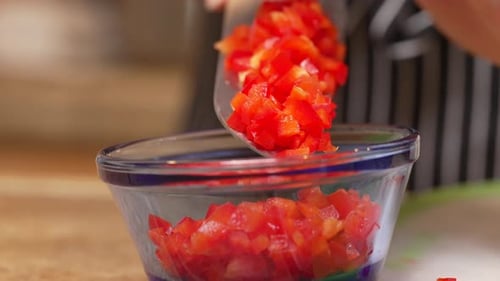 Diced Red Bell Pepper Being Poured Into Bowl