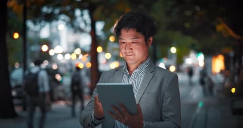 City, tablet and Asian businessman at night for communication, typing email and networking