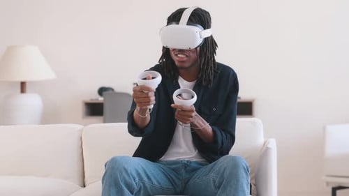 Man playing VR with headset and hand controllers