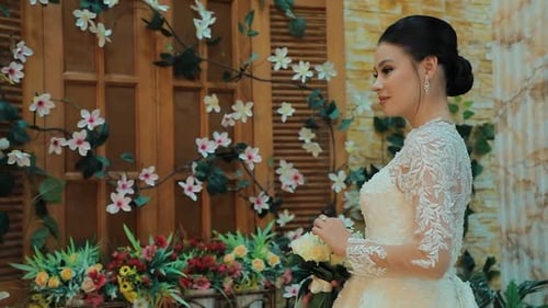 Elegant Bride Holds Bouquet in Floral Setting