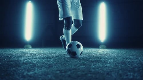 Football Dribbling Practice Closeup of Professional Football Player in Stadium at Night Training