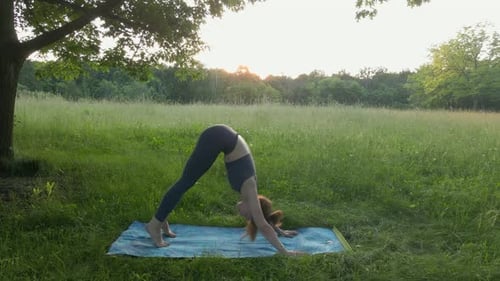 Young Woman Yoga Outdoors Keep Calm and Meditates While Practicing Yoga to Explore the Inner Peace