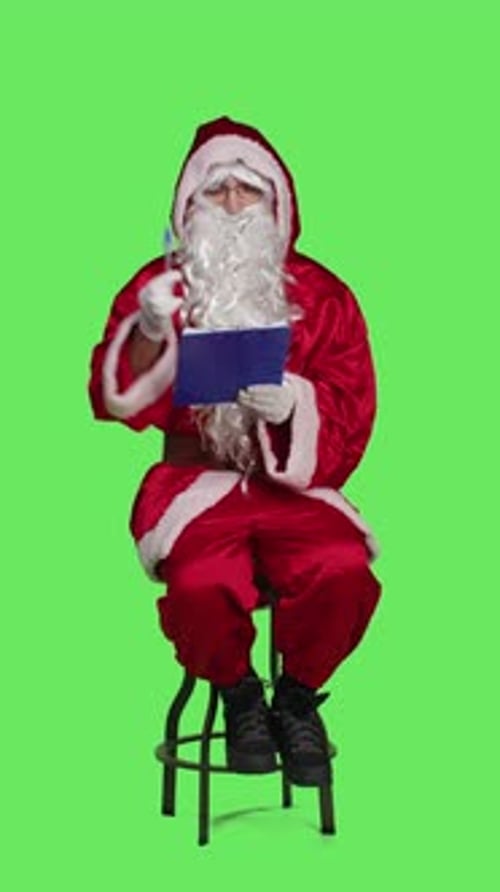 Vertical Video Front View of Saint Nick Writing Notes on Clipboard