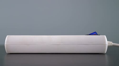 Extension Cord Being Turned On And Plugged In