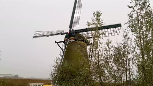 Landscape with windmills and cloudy weather