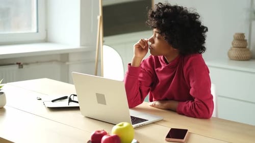 African American Girl Using Laptop at Home Office Looking at Screen Typing Chatting Reading Writing