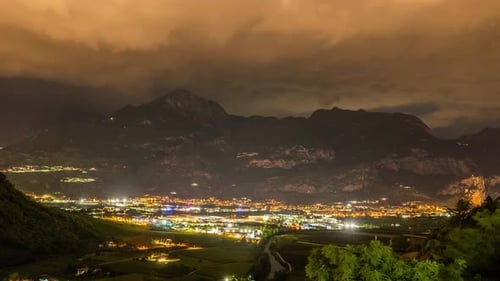 Timelapse of the City Under a Mountain at Night