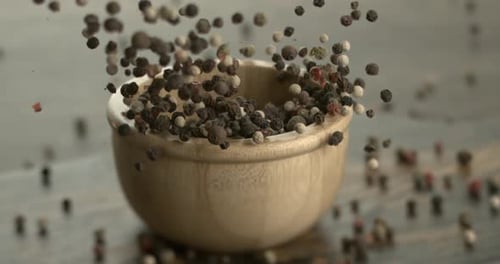 Mixed peppercorns in a super slow motion. Dry mix peppercorns close up.