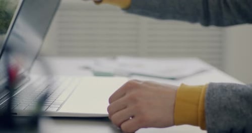 Closeup of Young Businessman Turning on Laptop and Typing Working with Computer in Office