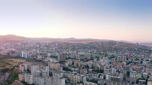 Beautiful sunset above Tbilisi urban skyline and mountains, Georgia