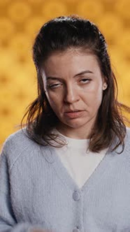 Vertical Video Disappointed Woman Bashing Book Showing Thumbs Down Sign Studio Background