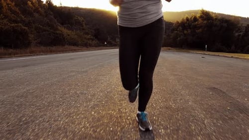 Road Runner Woman Running on Road in the Morning