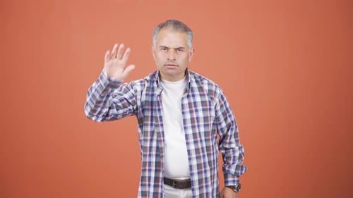 Man making stop sign for camera.