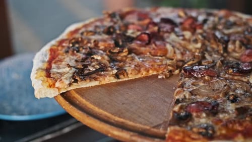 Close Up of Pizza with Sausage and Mushrooms