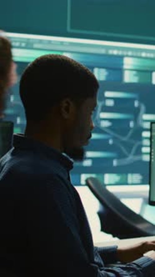 Man Working at Computer in Dark Office