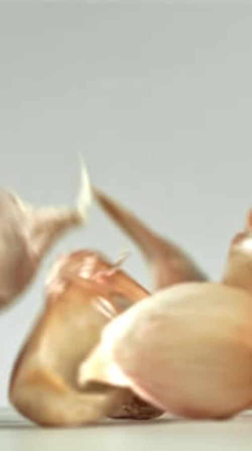 Fresh Garlic Falls on the Table Filmed on a Highspeed Camera at 1000 Fps