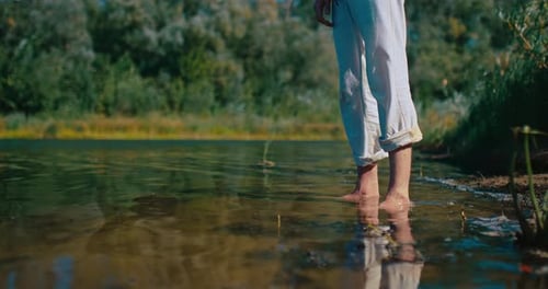 Legs of Young Man Standing in Water of River in Summer Day Closeup Details View Prores