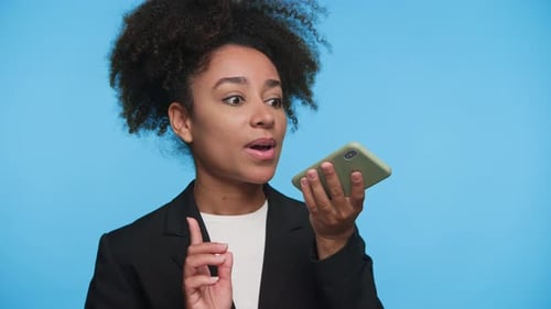 Woman Using Voice Command on Phone, Blue Background