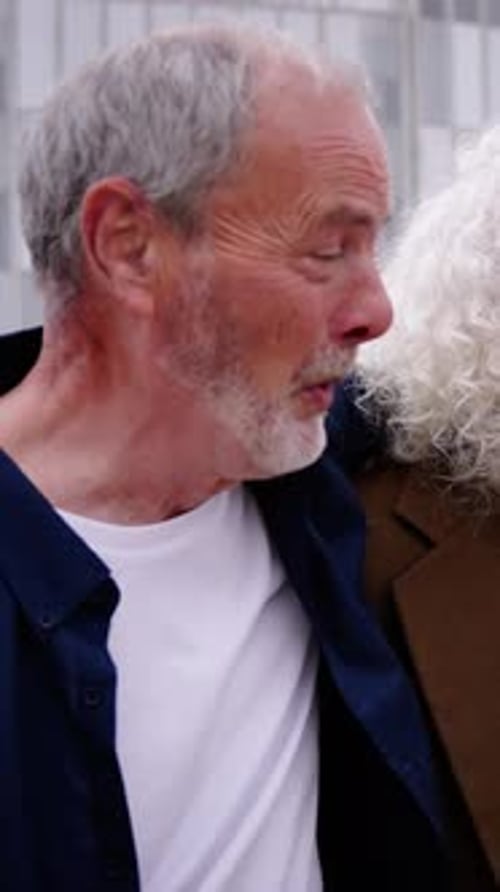 Group of Three Mature Caucasian Men Enjoying Embracing Walk Together Laughing Outdoor
