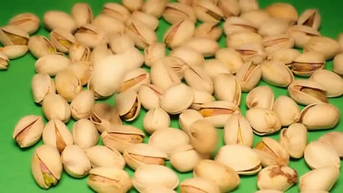 Pistachios on a Green Background