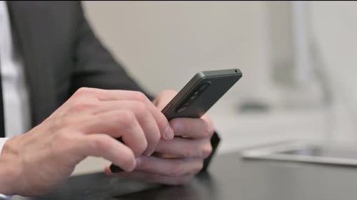 Close up of Businessman Using Phone, Typing