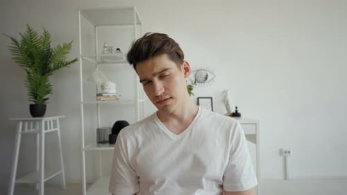 Tired Man Rubs Face and Rests Head