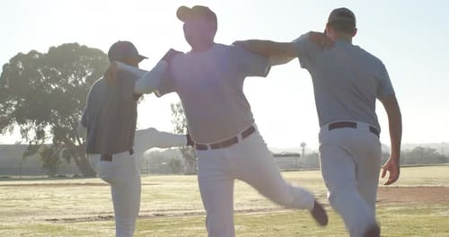 Performing synchronized warm-up kicks across outfield, Diverse male teammates wearing caps, cleats