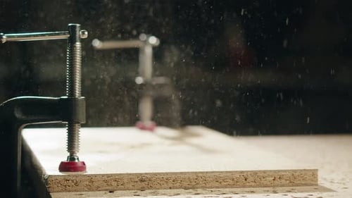 Clamped Board in Workshop with Floating Dust