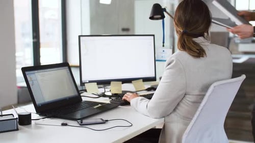 female programmer with computer working and taking fo