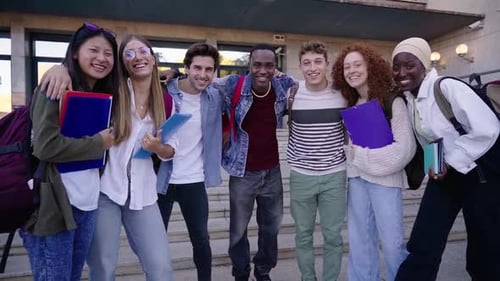 Portrait of Multiracial Group of Students Embraced Looking at Camera Smiling Outside University