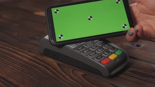 Top View of Person Using Contactless Payment with Smartphone with Green Screen