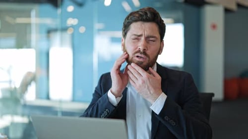 Businessman Suffering From Severe Toothache At Office