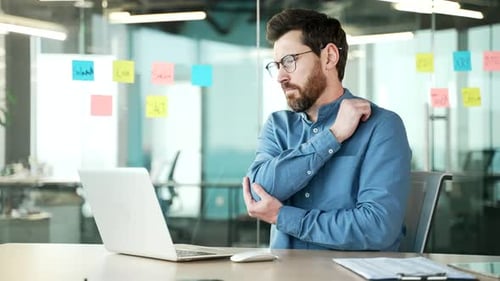 Man in Office Rubs Sore Shoulder, Elbow