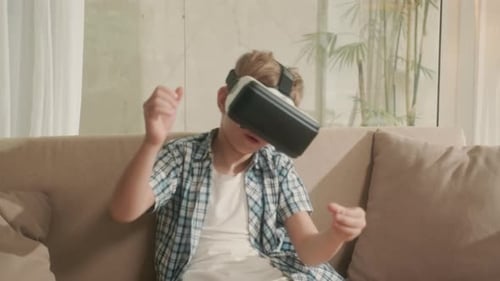 Child Using Virtual Reality Headset on Couch
