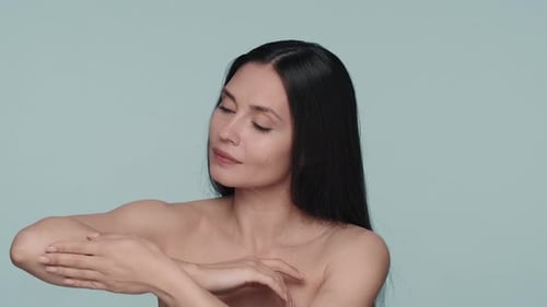 Portrait of a Seminude Woman in the Studio on a Blue Background Close Up A Woman Enjoys the Velvety