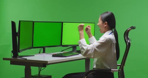 Happy Woman Celebrating And Dancing While Working With Mock Up Multiple Monitor In Green Screen
