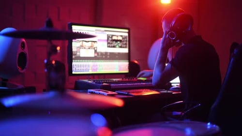 Sound engineer working and mixing music indoors in the studio