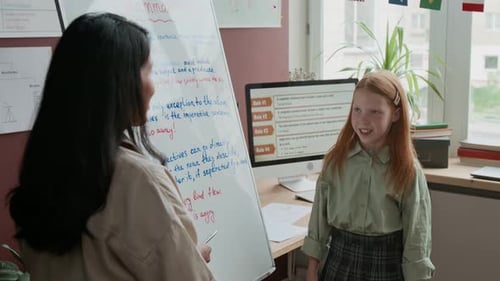 Young Student Learning Grammar From Teacher in Classroom