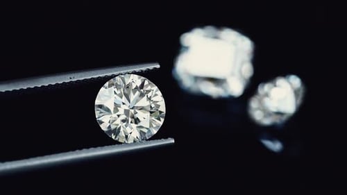 Close Up of Diamond held by Tweezers